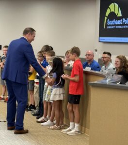 Dr. Halupnik gives medals to Math Star students