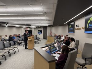 Halupnik thanking Powell at Board Meeting
