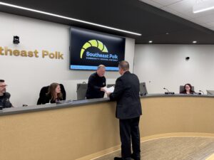 Halupnik thanking Powell at Board Meeting