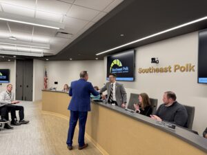 Dr. Dirk Halupnik present Team Achievement award to board