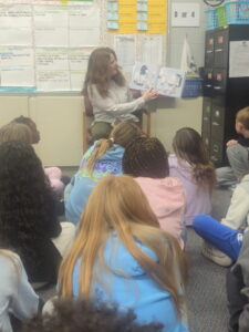 Board member Brigid Ernst reading to Four Mile students