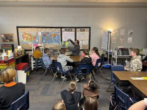 SEP CFO Kevin Baccam reading to Four Mile 4th graders