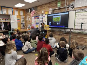Board member Kelly Simmons reading to Four Mile 2nd graders
