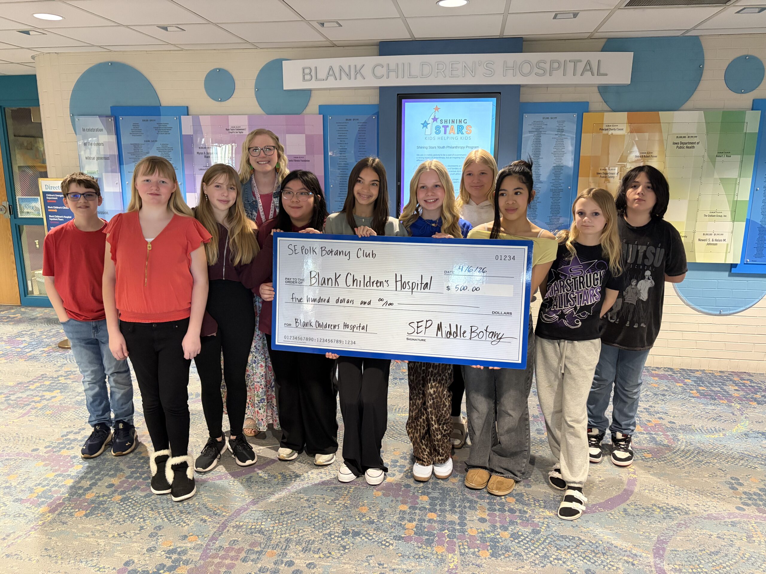 Middle School Students with an oversized check to Blank Childrens Hospital