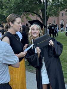 Graduate posing after graduation, smiling