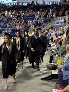 Graduates walking out, getting hand shakes