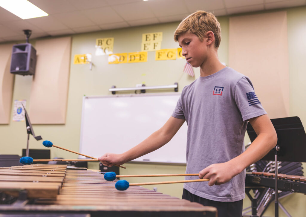 A student plays an instrument during band. 