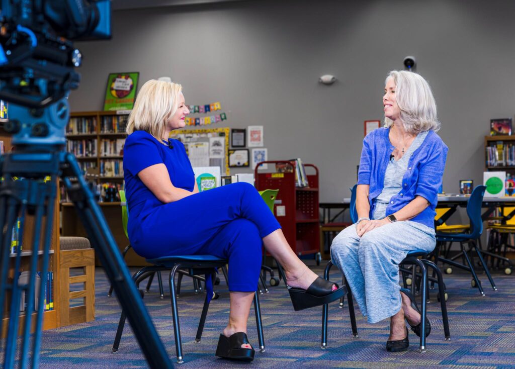 A photo of WHO-13 Anchor and Mrs. Hoyt sitting down for an on camera interview.